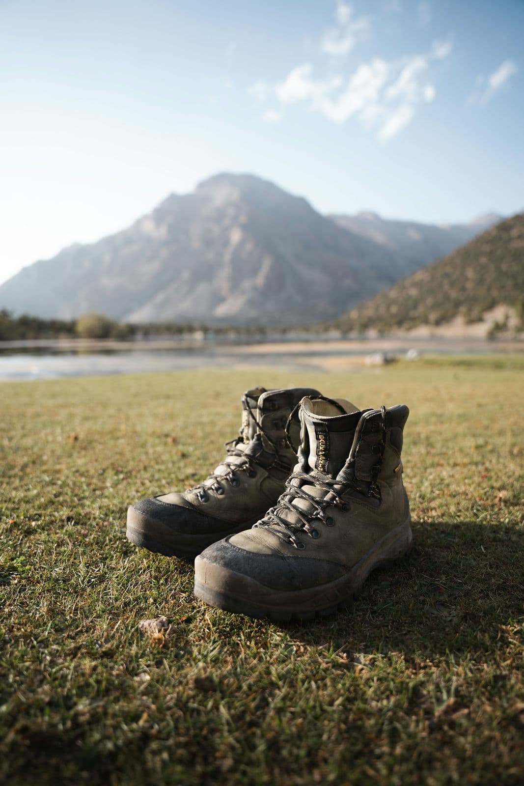 Close-up of trekking shoe outsole showing deep lug pattern for grip on rocky mountain terrain