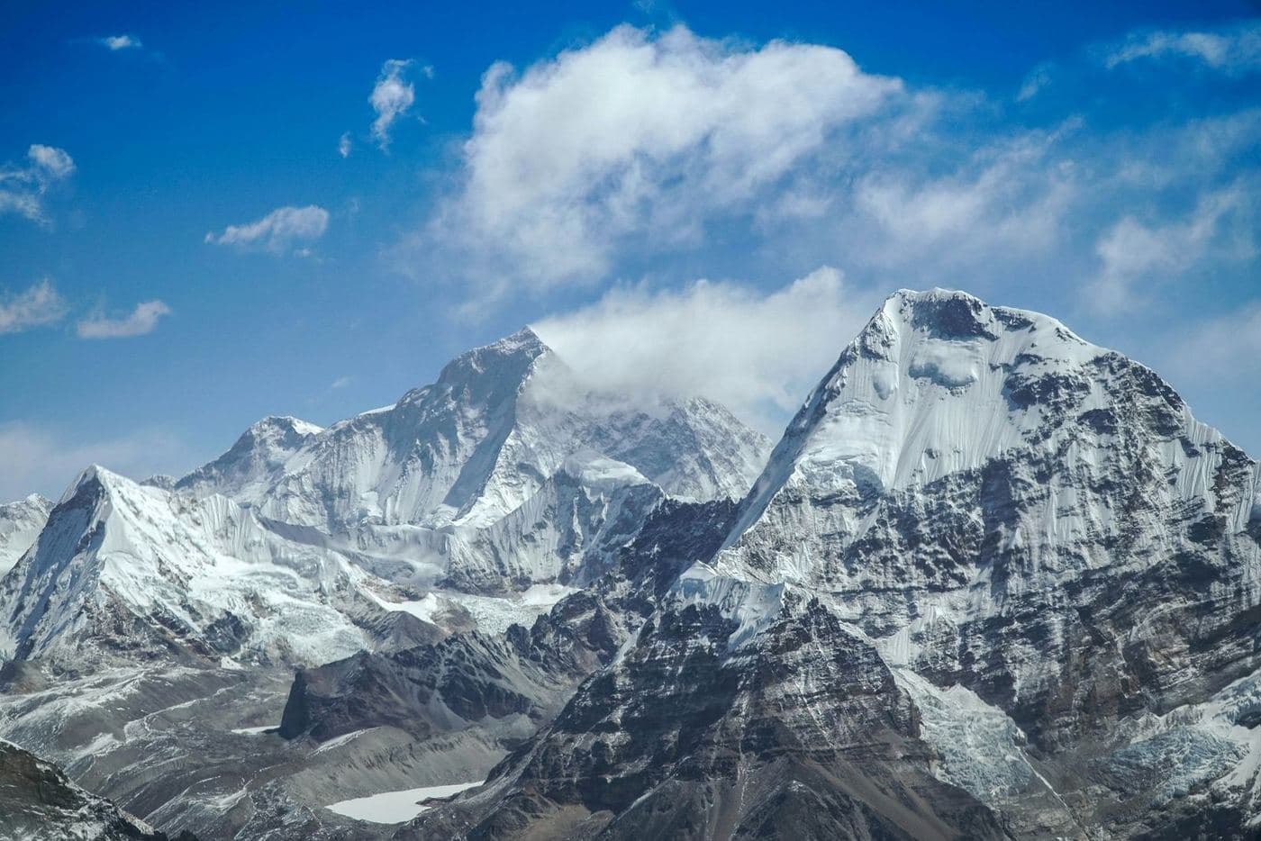 Crystal clear view of snow-covered Himalayan peaks against deep blue sky in October after monsoon withdrawal