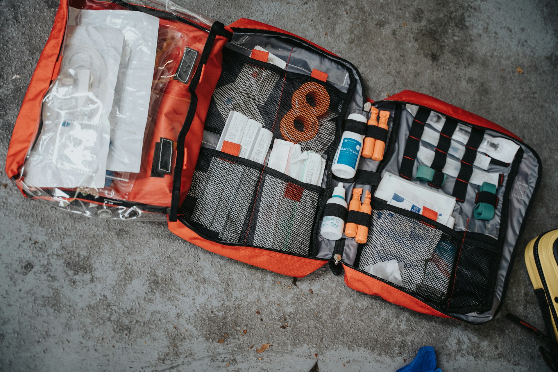 Open first aid kit with bandages antiseptic and medical supplies for mountain travel